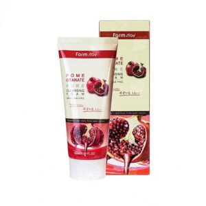 A tube of farm stay pomegranate pure cleansing foam alongside its packaging box, featuring images of pomegranates to highlight the product's natural ingredient.