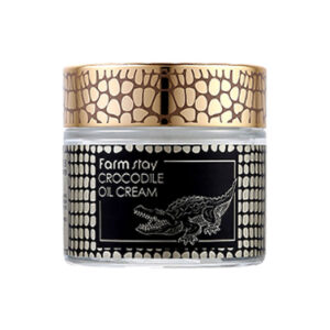 A jar of crocodile oil cream with a luxurious design, featuring a golden lid and black label with crocodile illustration.